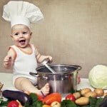 little baby in a chef’s hat and ladle in hand
