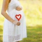 Pregnancy, maternity, family – concept, pregnant woman and heart