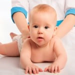 Doctor holds baby massage therapy